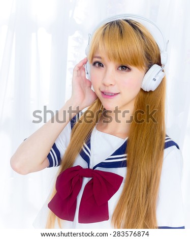 Asin girl in student sailor suit japanese style listen to music