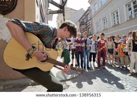 VILNIUS, LITHUANIA - MAY 18: Unidentified musician play guitar in Street music day on May 18, 2013 in Vilnius. Its a most popular event on May in Vilnius, Lithuania