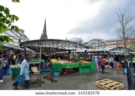 BIRMINGHAM, ENGLAND - JUNE 13: Unknown people in Bull Ring market on June 13, 2013 in Birmingham, England. Birmingham\'s outdoor Bull Ring market sees over six million shoppers every year