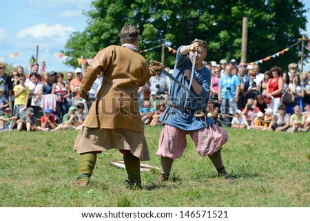 KERNAVE, LITHUANIA - JULY 7: Unidentified people in a Medieval fights at 14th International Festival of Experimental Archaeology on July 7, 2013. Its a most popular folklore event on July in Lithuania