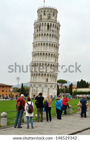 PISA, ITALY - APRIL 29: Tourists visit leaning tower in Pisa, Italy on April 29, 2013. It is one of the main centers for medieval art and Unesco World Heritage