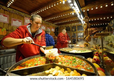BERLIN - NOVEMBER 23: Unidentified people trades food in annual traditional Christmas fair in Potsdamer Platz (Potsdam Square) on 23 November 2013 in Berlin, Germany.