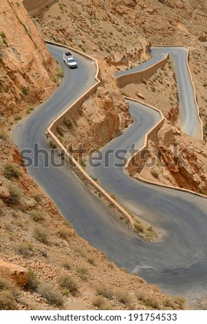 DADES GORGES, MOROCCO - JULY 11: Car on a winding road, July 11, 2013 in Dades Gorges, Morocco. Road in Dades Gorges very popular tourist route in east Morocco.