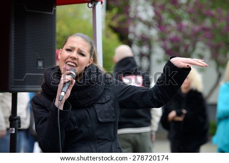 VILNIUS, LITHUANIA - MAY 16: Unidentified young musician sings in Street Music Day on May 16, 2015 in Vilnius. Its a most popular event on May in Vilnius, Lithuania