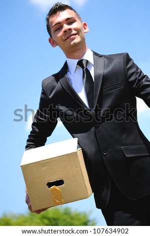 Business man delivery box in nature