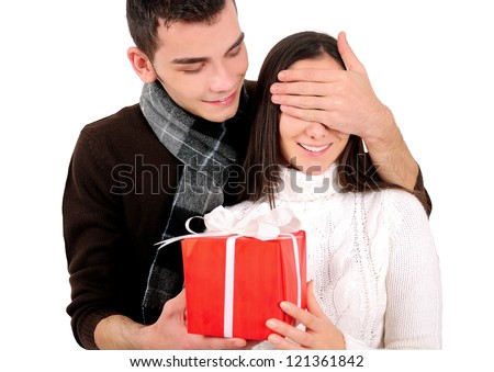 Isolated young casual couple with gift