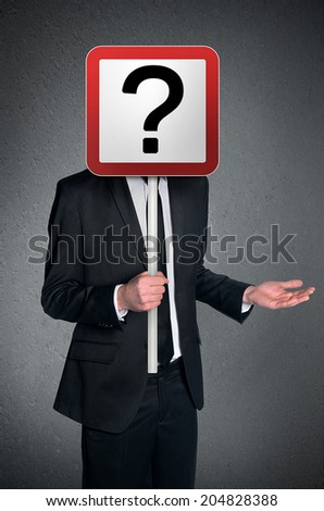 Business man holding question mark sign