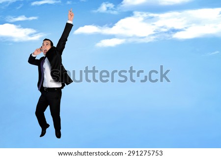 Business man happy jump talking phone