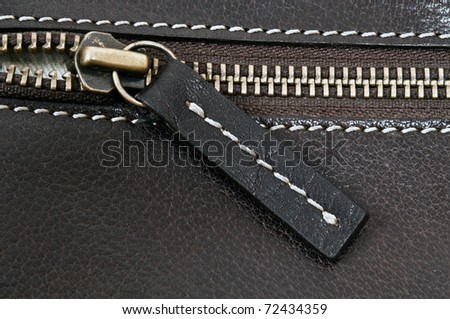 Close up to zip on leather material