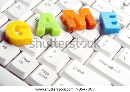 Game word made by colorful letters on keyboard