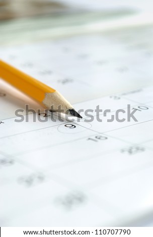 calendar and a pencil to mark the desired date