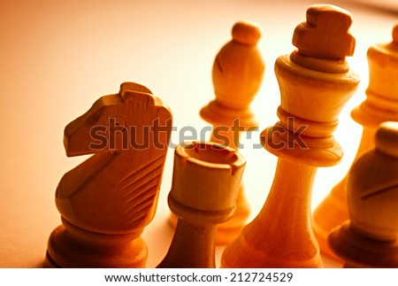 Close-up of wooden vintage chess pieces as knight, pawn, king and bishop
