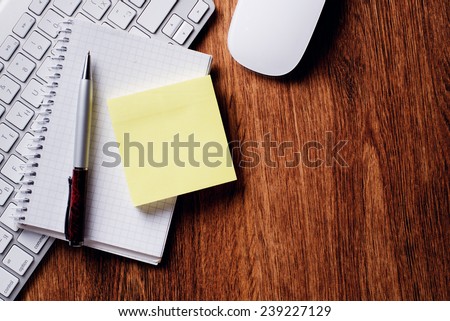 Conceptual Ballpoint Pen and Clean Notes with White Computer Keyboard and Mouse on Top of Wooden Table with Copy Space.