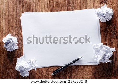 Conceptual Blank White Papers in Horizontal and Black Pen with Crumpled Papers on Sides, Emphasizing Copy Space at the Center.