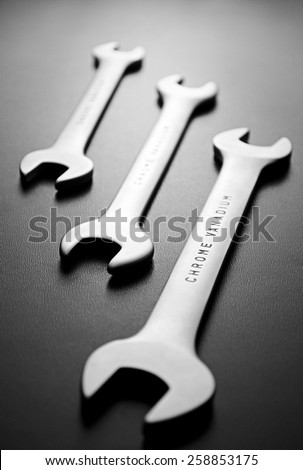 Close up Three Open Ended Wrenches Hand Tools Positioned Diagonally on a Gray Background.