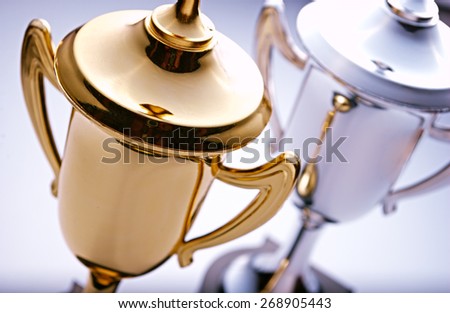 Gold and silver trophies waiting to be awarded to the winner and runner-up in a competition with focus to the gold cup in front