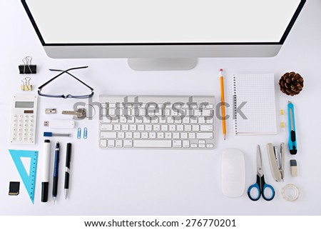 The white office table with stationery accessories, keyboard,computer mouse and notepad. Top view.