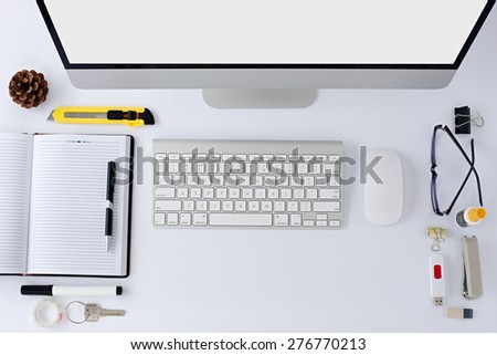 The white office table with stationery accessories, keyboard,computer mouse and notepad. Top view.