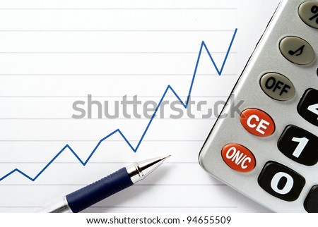 pen, calculator and a chart on a sheet of paper