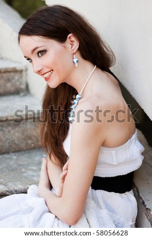 model, beautiful happy girl,  outdoor, sunny clear day fashion jewelry sitting on steps
