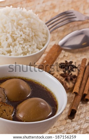Eggs and pork in brown sauce and rice.