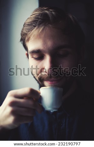 young guy drinking coffee