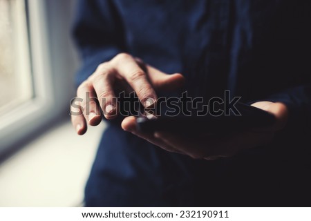 tablet in the hands of a young guy