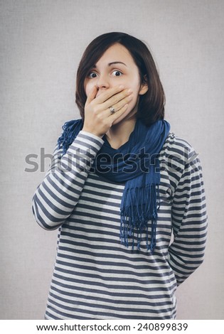 Surprised woman with hand over her opened mouth and big eyes