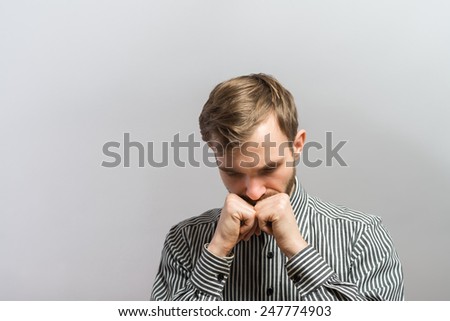 Nervous man biting his fist