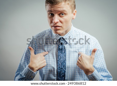 Closeup portrait of angry, unhappy, annoyed young man, getting mad, asking question: you talking to me, you mean me? Isolated on white background. Negative human emotion, facial expression, feelings