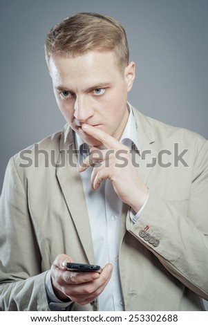 Handsome businessman checking emails on the phone