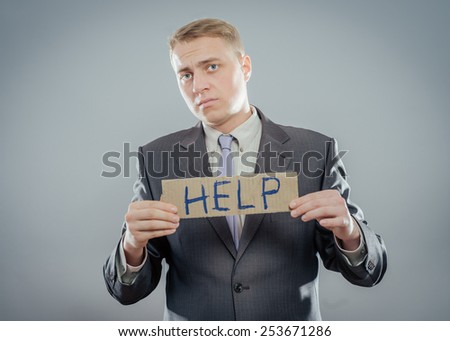 Man holding paper with help text