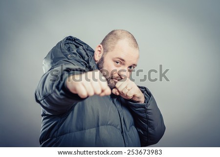 Closeup portrait of an angry businessman threatening with his fist