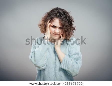 Closeup portrait of young, upset, sad depressed, worried, troubled brunette woman holding her head with both hands, isolated. Human emotions, face expressions, feelings, perception
