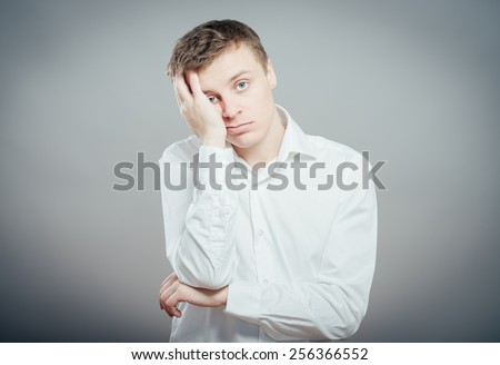 Closeup portrait of a groggy upset worried sad, depressed, tired business man with a headache and very stressed hand in hair, isolated , Negative human emotion facial expression