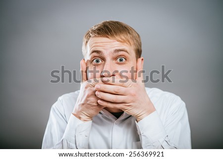 young scared  with hand covering mouth