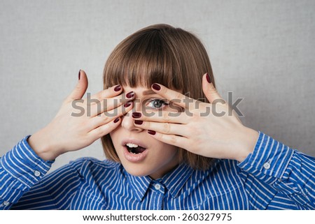 young girl covering her eyes/ isolated