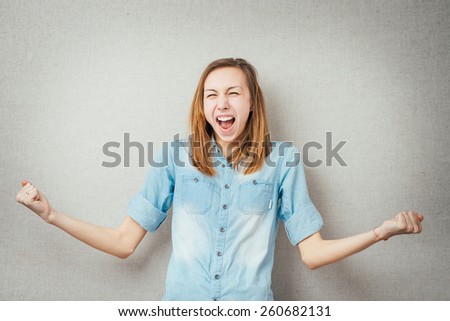 woman victory gesture hands up. isolated on gray background