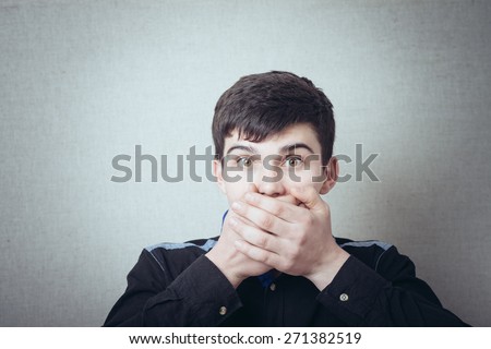 Man covers his mouth with his hands not to say