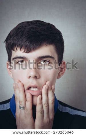Man thinking about something, shock, surprise, bad teeth hurt, sadness, dreams, tired. On a gray background.