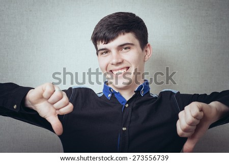 young man showing thumbs down