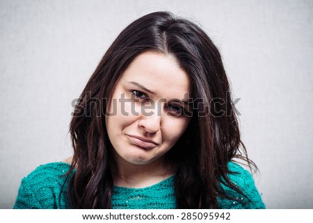 brunette girl is offended on a white background