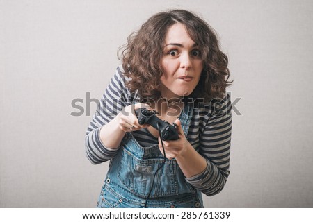 Cute girl playing on the joystick in a game console