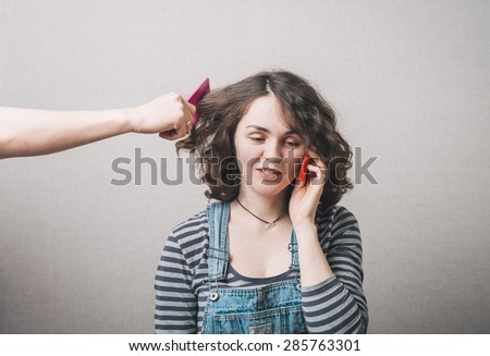 woman doing make up with many hands and arms helping her get the job done faster. girl making phone call by sell phone