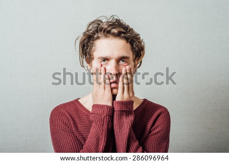 Closeup portrait, headshot young tired, fatigued business man worried, stressed, dragging face down with hands. Negative human emotions, facial expressions, feelings