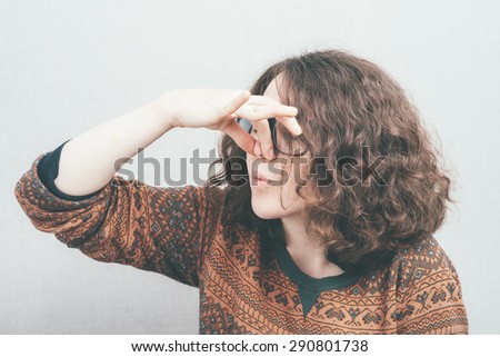 girl covers his nose because bad smell