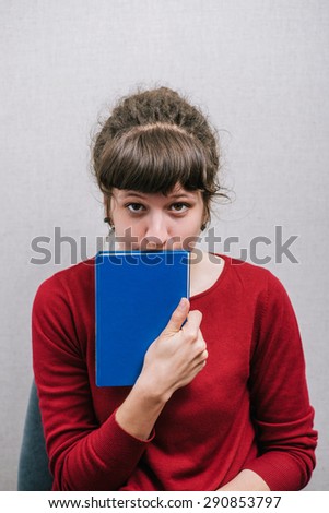 The woman with the book. On a gray background.