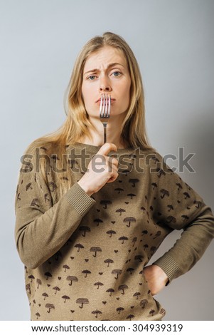 Girl eating with a fork