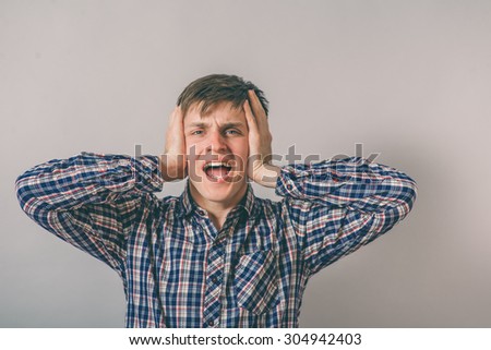 man covers his ears with his hands