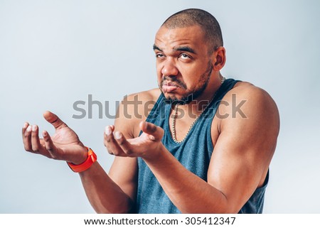 a dark-skinned man holding something invisible in his hands